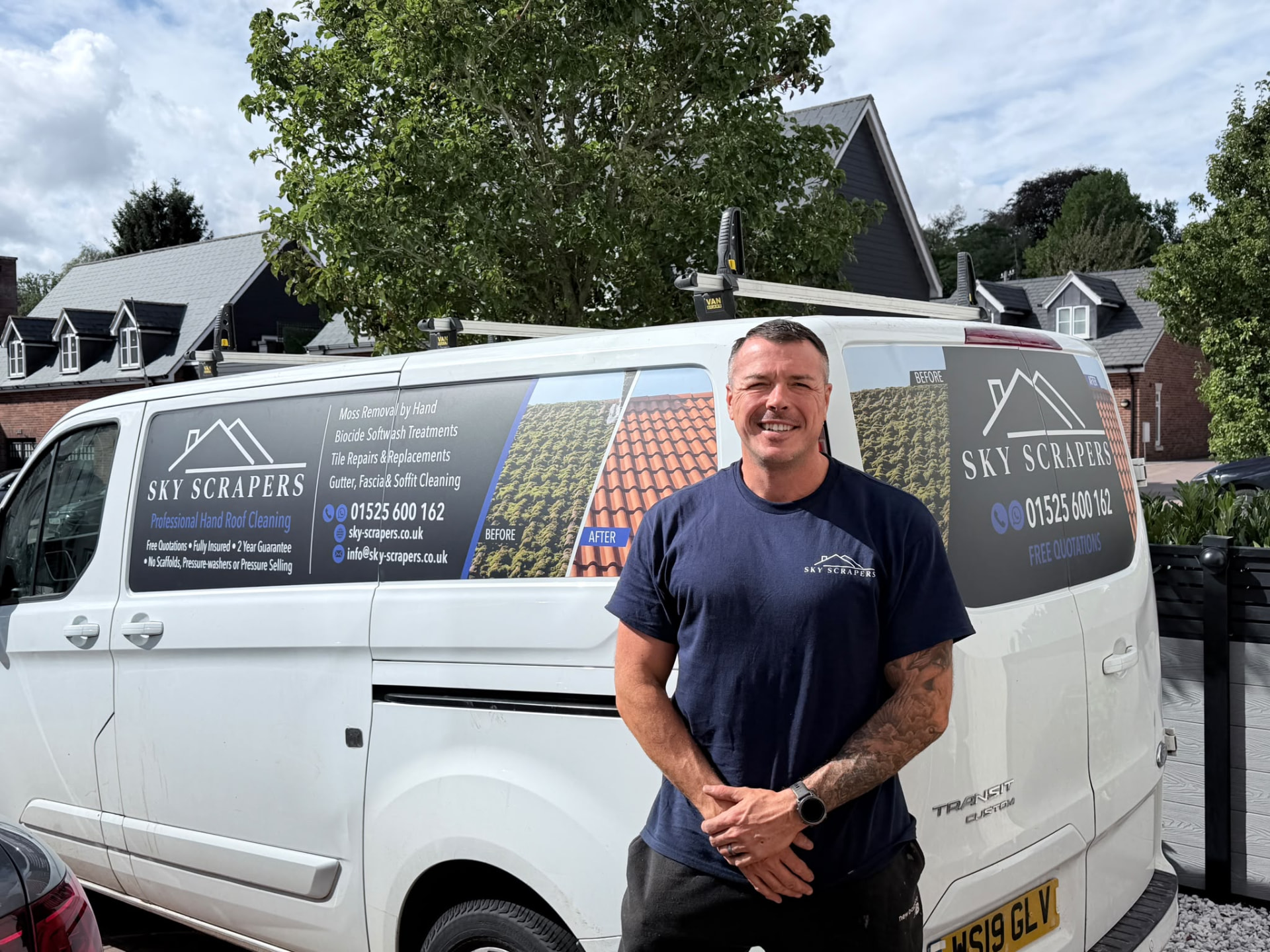 Patrick from Sky Scrapers Ltd standing beside a signwritten company van