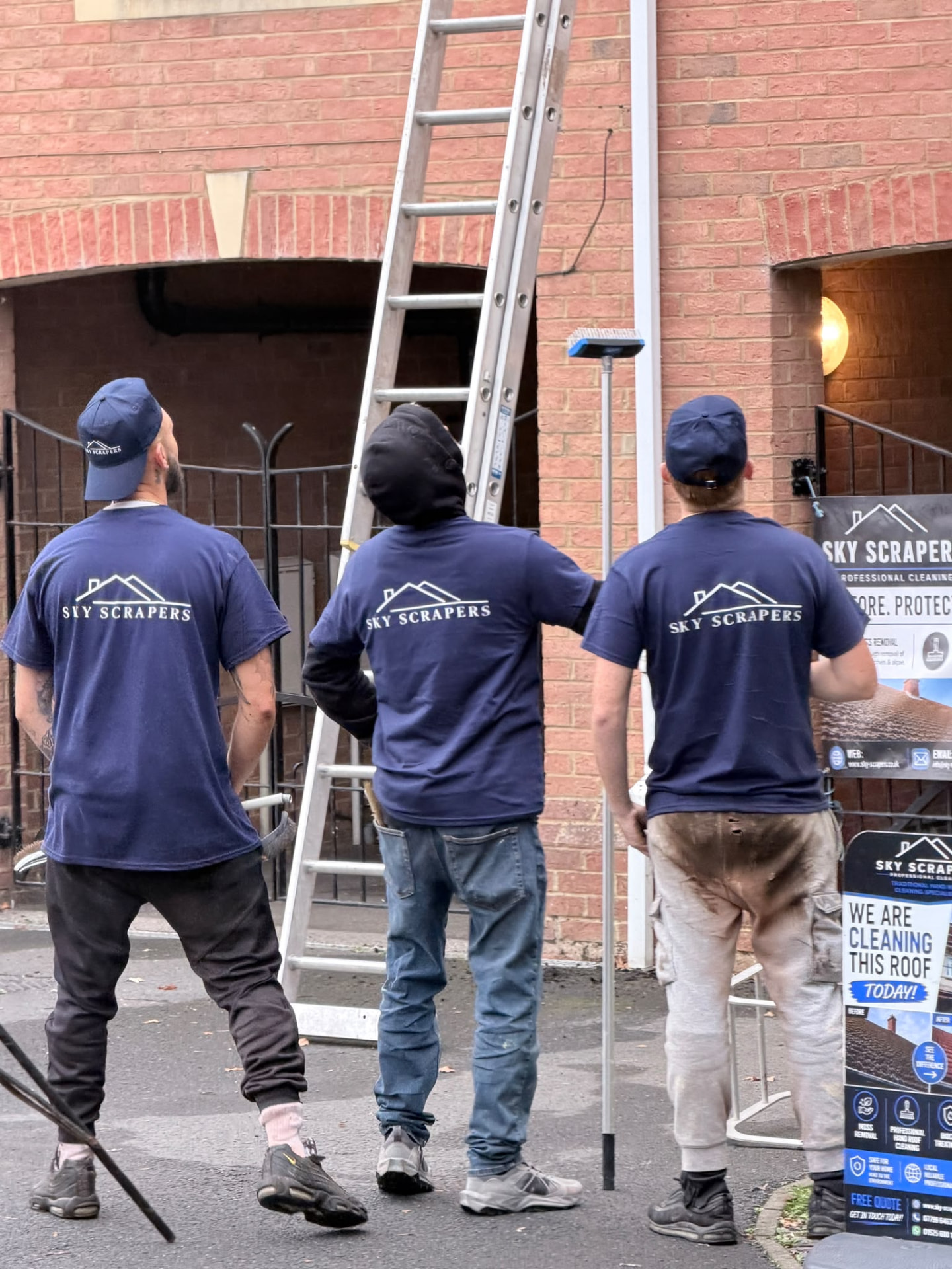 Three Sky Scrapers Ltd team members planning ladder access at a customer's home