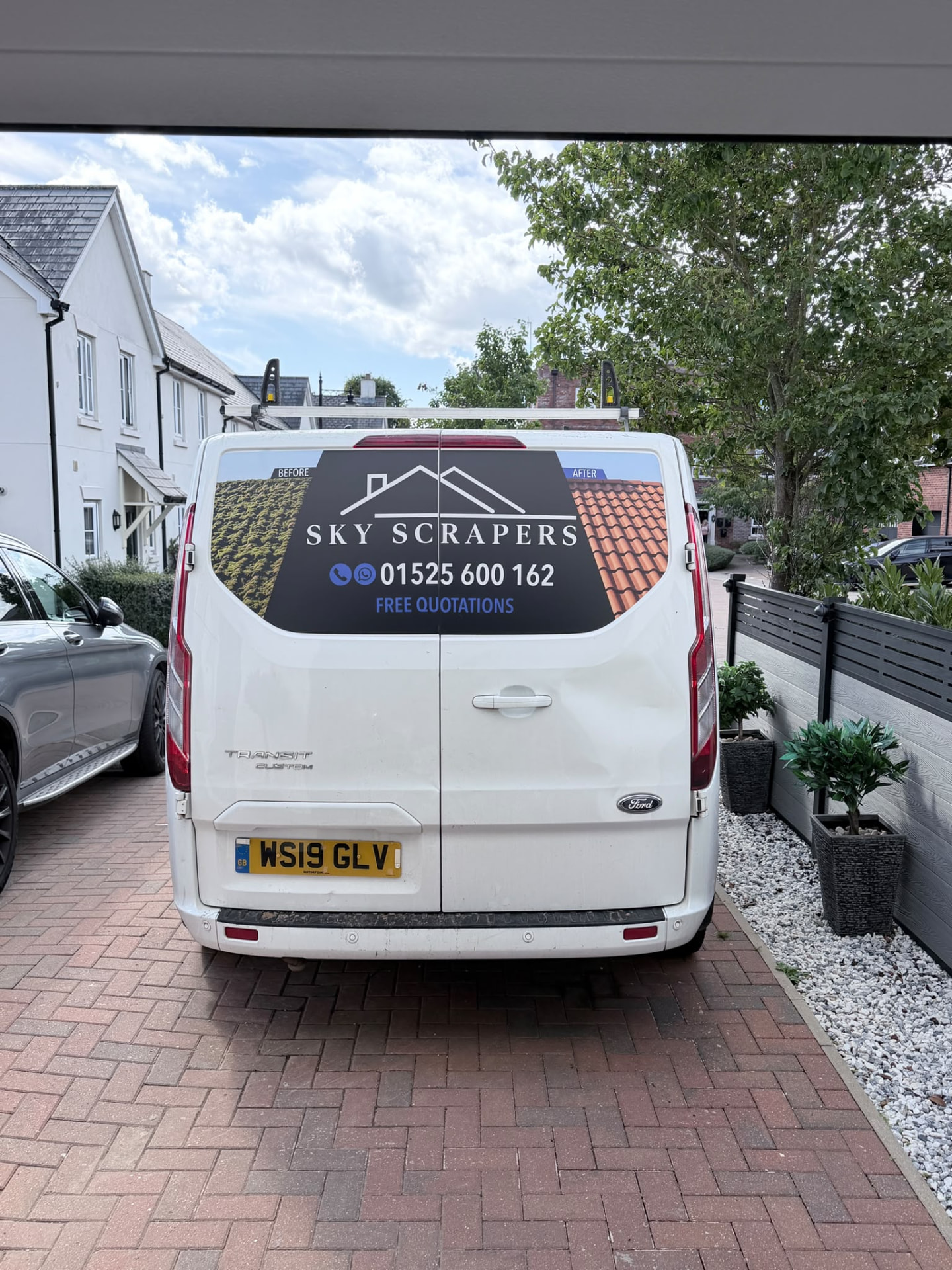 Rear of a Sky Scrapers Ltd signwritten van showing 01525 600162
