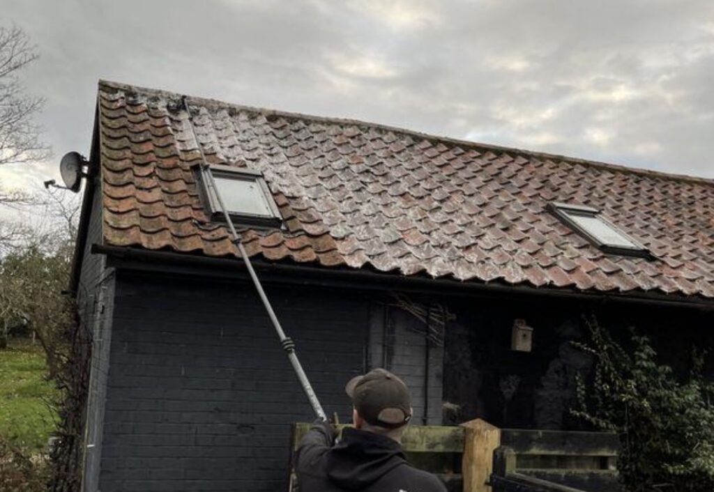 a cleaned pitched roof on a detached house — an example of moss removal of the kind we carry out on Bedfordshire homes near Flitwick